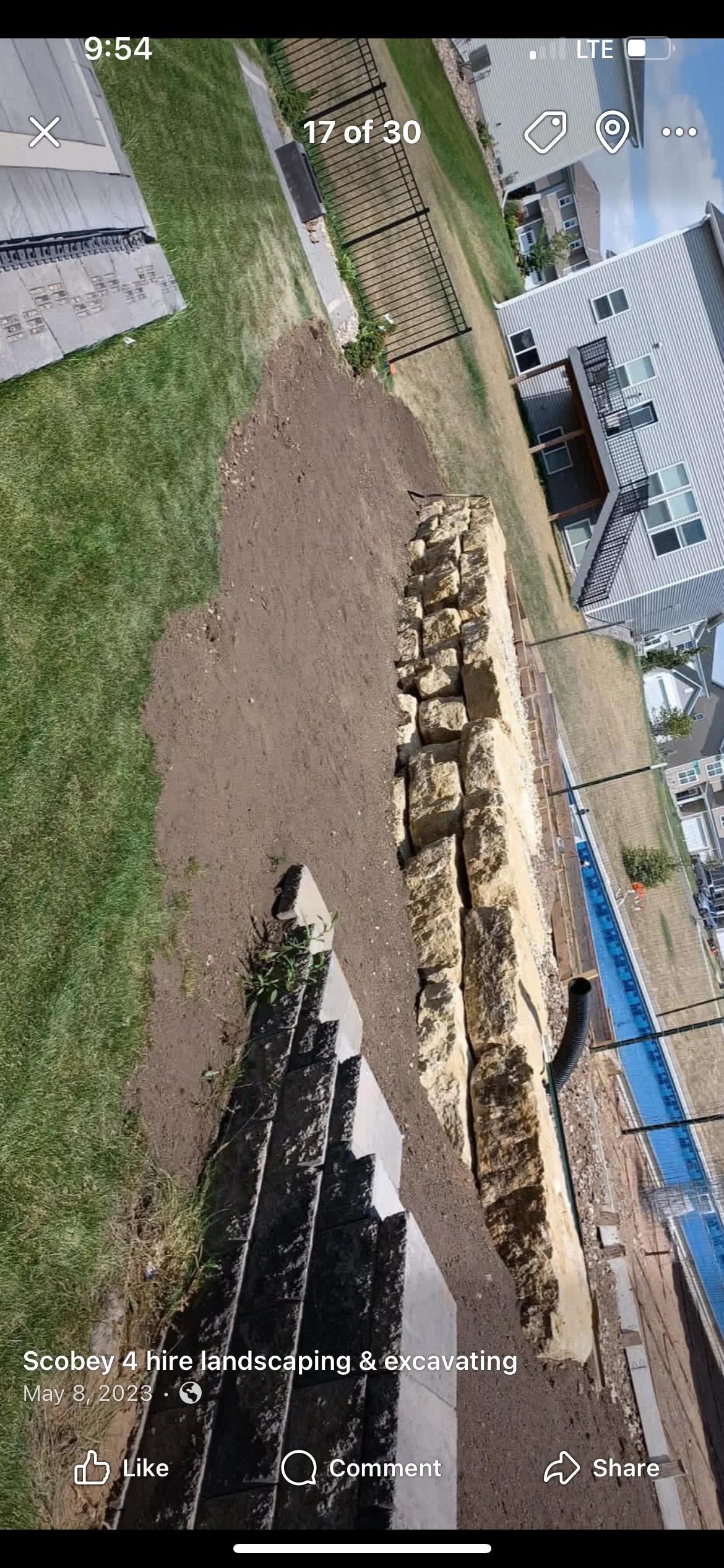 Aerial view of excavated driveway site with stone base and landscape fabric installation